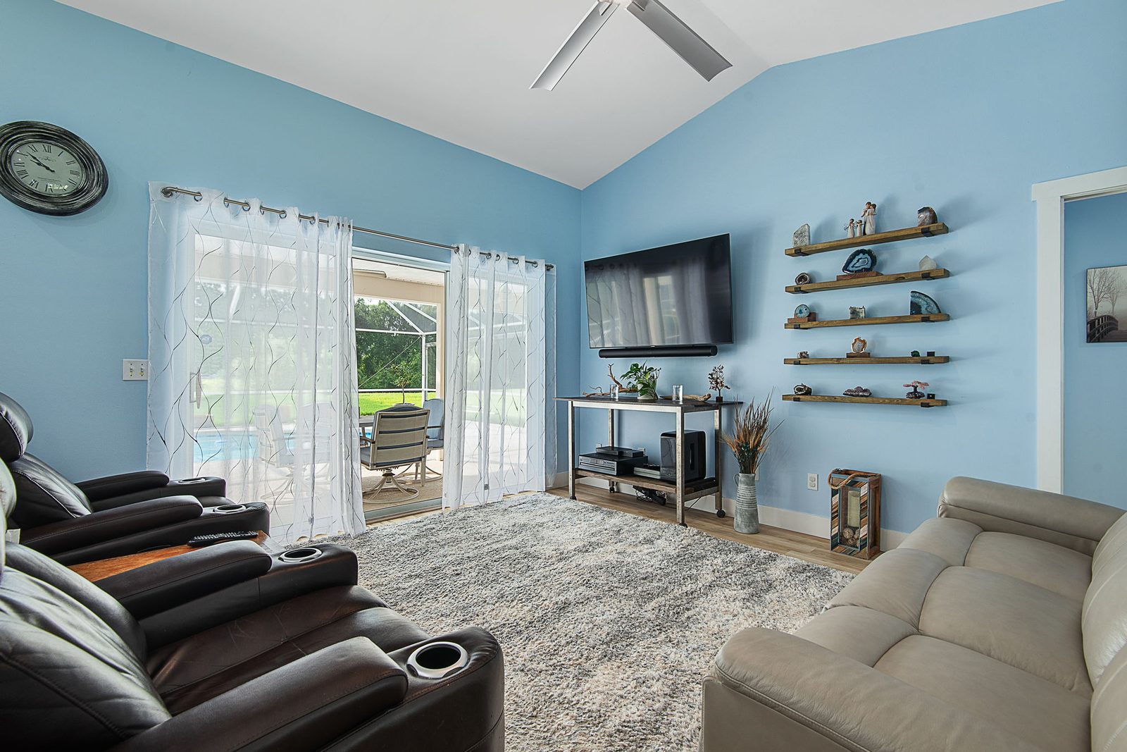 Living room with pool view through sliding glass doors